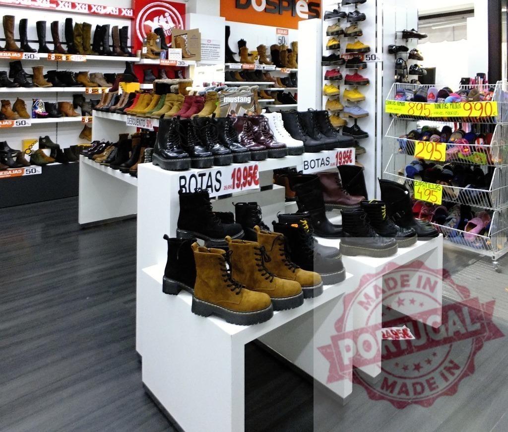 Shoe store displaying various boots and footwear for sale | Shoe store interior with boots and shoes on shelves and displays, prices visible - Realisiert mit Pictrs.com