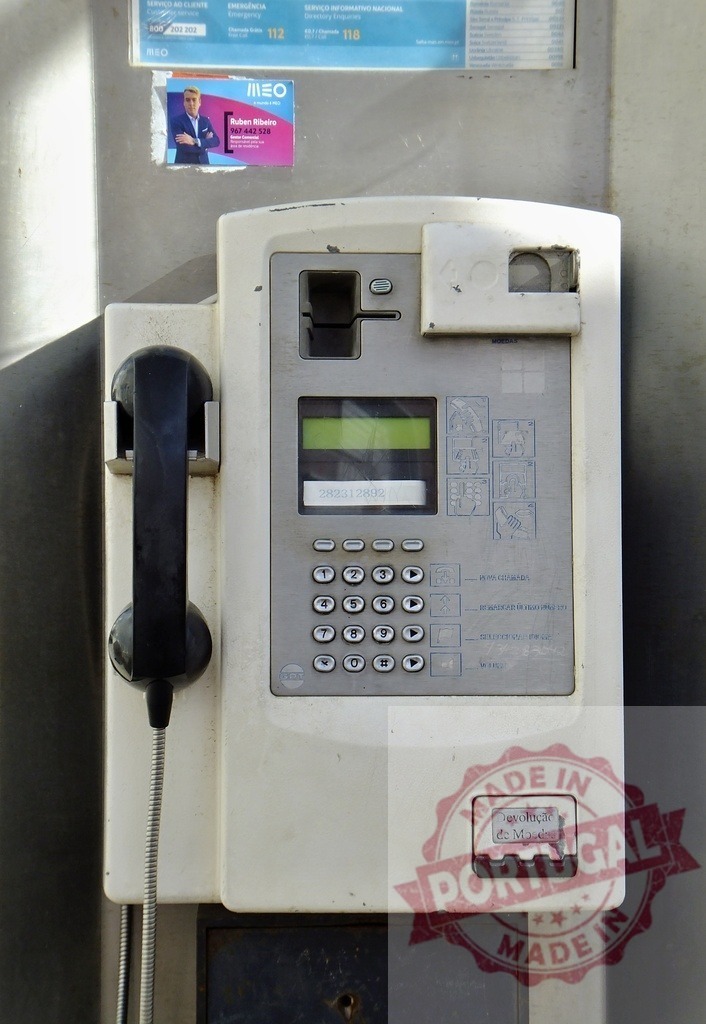 Old and dirty public phone showing credit balance is hanging on a wall | Close-up of an old and worn public telephone displaying a credit balance, mounted on a wall - Realized with Pictrs.com