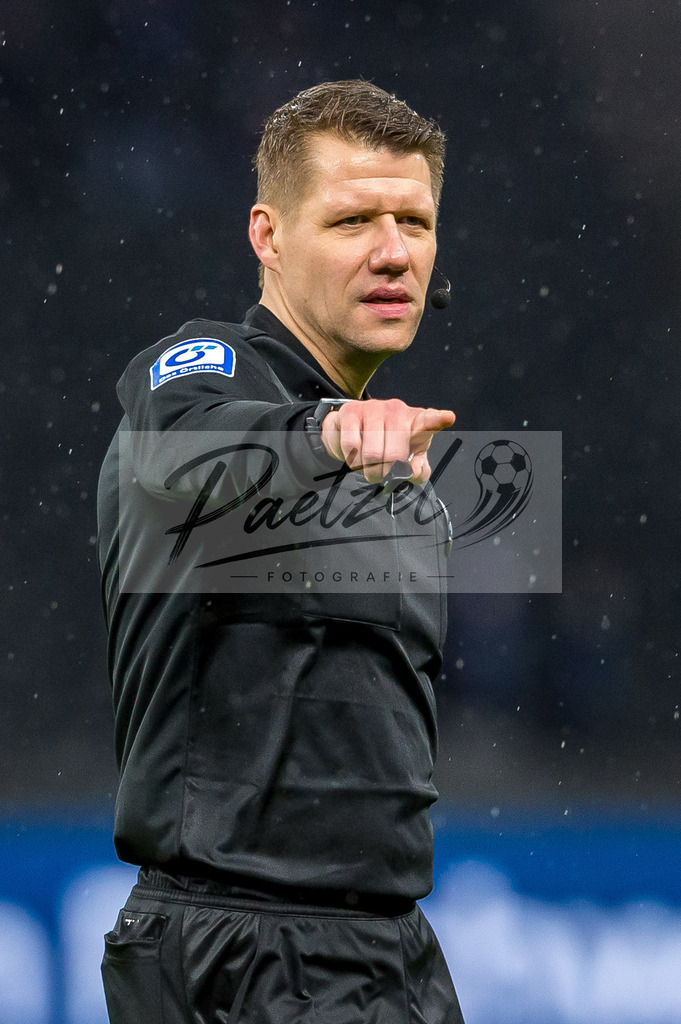 BSCRBL20220220_195 | Fussball, Herren: Schiedsrichter Patrick Ittrich gestikuliert, Gestik bei dem Spiel der 1. Bundesliga zwischen Hertha BSC und RB Leipzig im Olypiastadion am 20.02.2022 in Berlin, Deutschland.DFB / DFL REGULATIONS PROHIBIT ANY USE OF PHOTOGRAPHS AS IMAGE SEQUENCES AND/OR QUASI-VIDEO. - Realisiert mit Pictrs.com