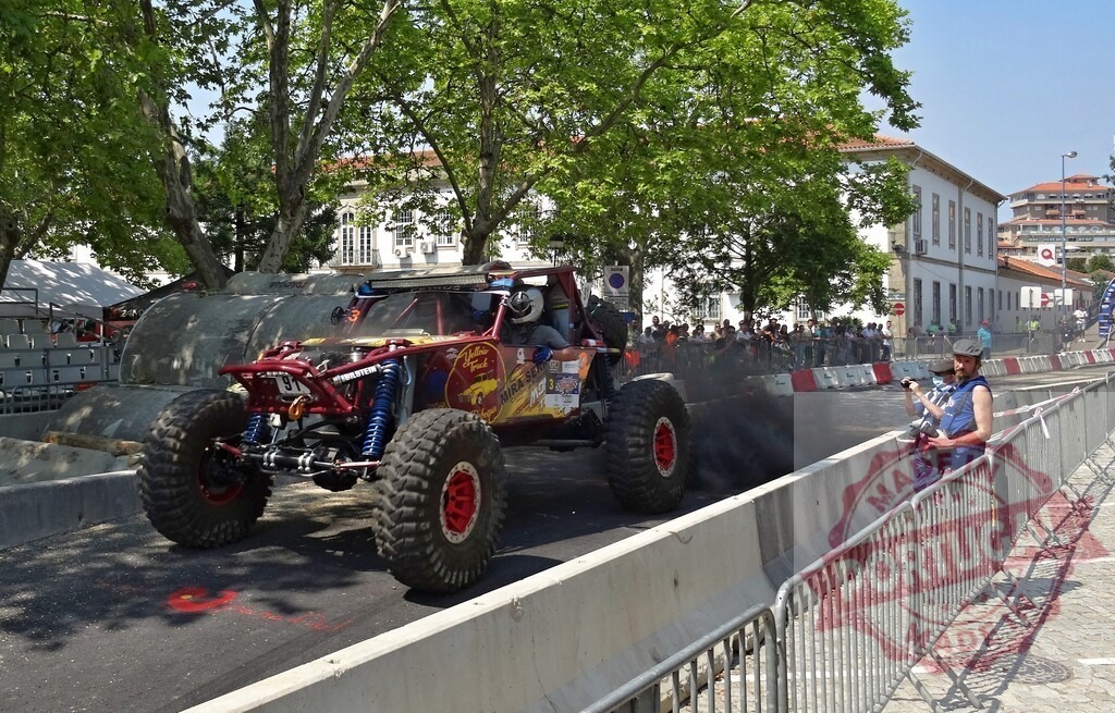Buggy racing through city streets during motorsport competition | Professional driver drifting with buggy during urban race competition - Realized with Pictrs.com