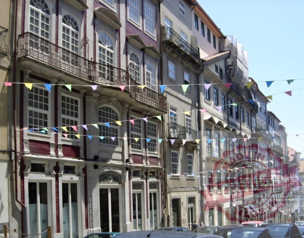 Porto Ribeira street with bunting for sao Joao festival. Porto - Portugal | Traditional architecture lining a old street decorated with festive bunting - Realized with Pictrs.com