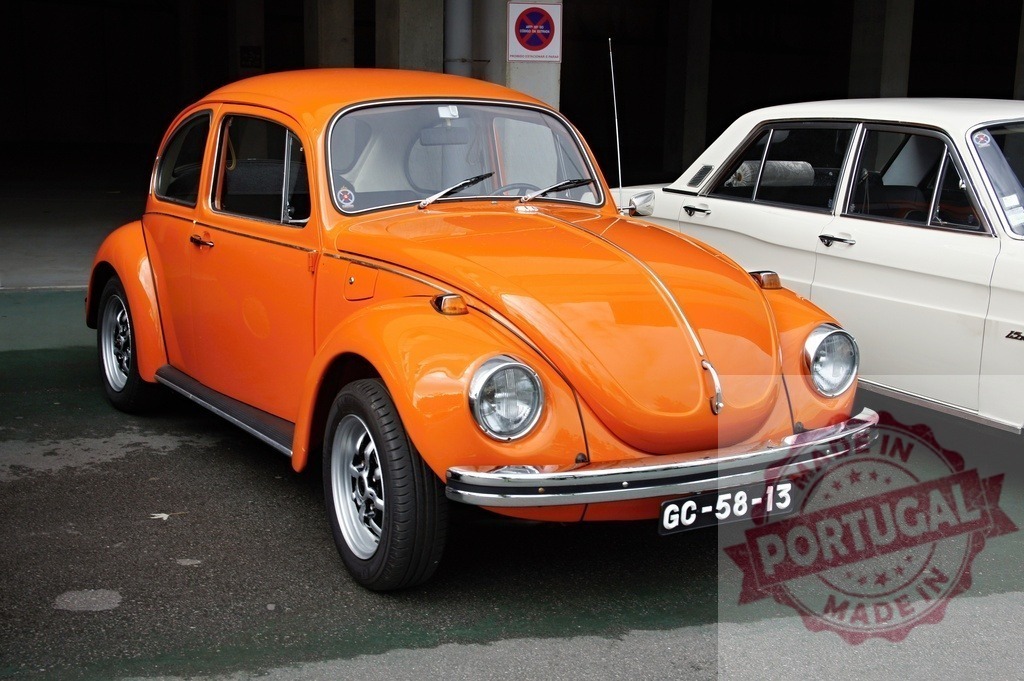 Orange Volkswagen Beetle parked near a white car | Classic orange Volkswagen Beetle parked in a parking lot, near a white Ford Taunus - Realized with Pictrs.com