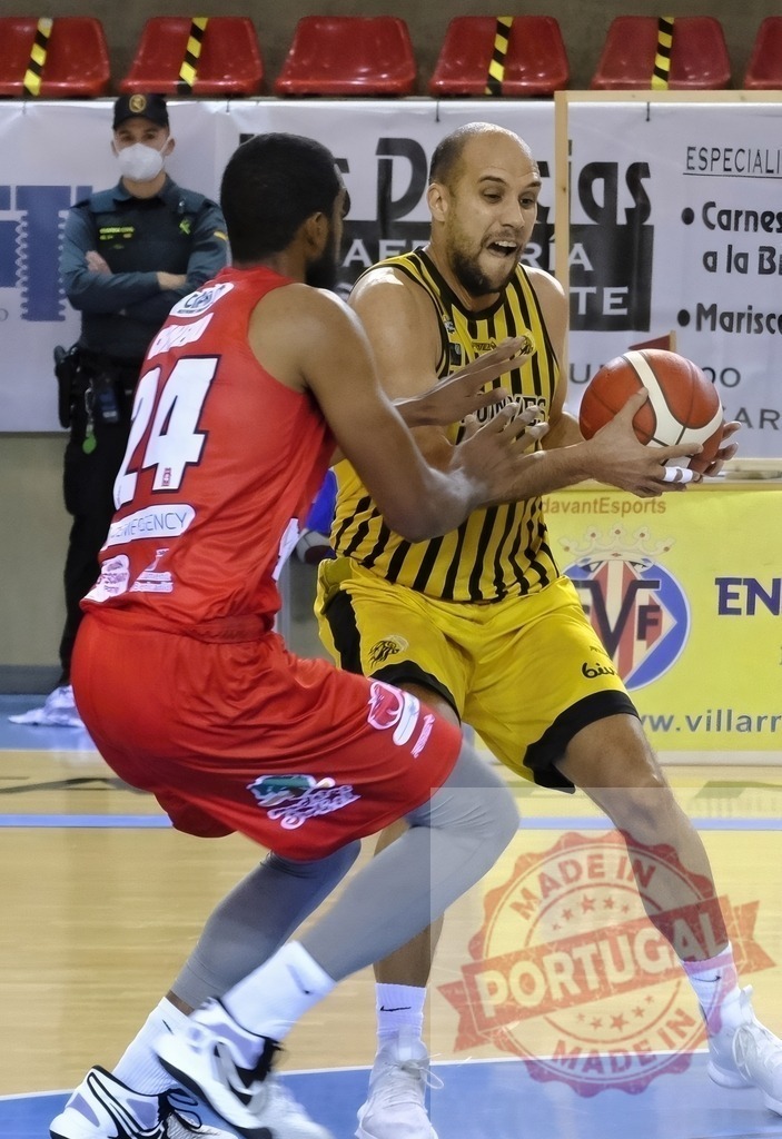 Basketball players competing during sports game on court | Basketball player in yellow jersey dribbling ball while defender blocks during game - Realized with Pictrs.com