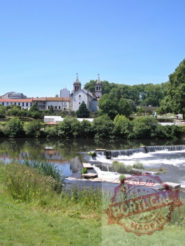 Ave river in Vila do Conde with church and tranquil park. Norte - Portugal | Ave river flowing past a historic church and green parkland in Vila do Conde, Portugal - Realized with Pictrs.com