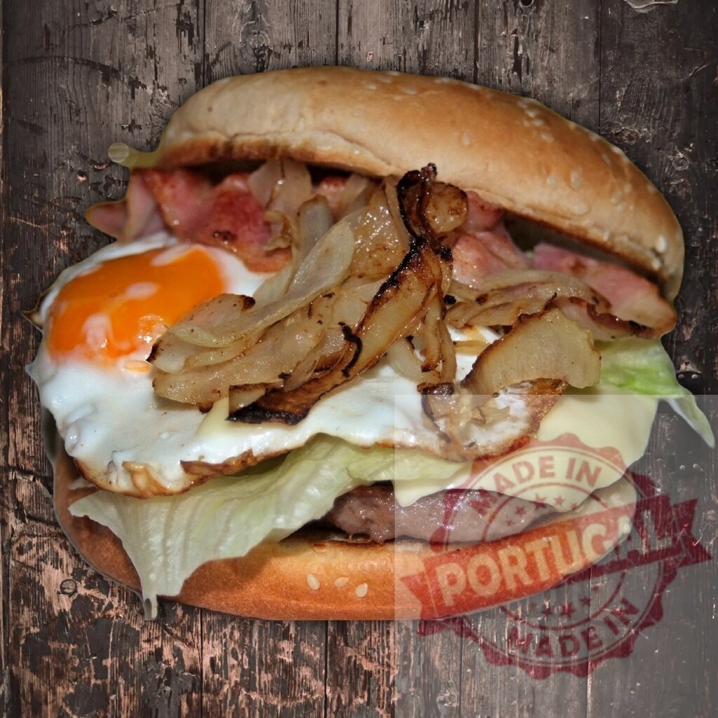 Delicious bacon egg cheeseburger with grilled onions | Hamburger bun filled with beef patty, a fried egg, bacon, grilled onions, cheese, and lettuce - Realized with Pictrs.com