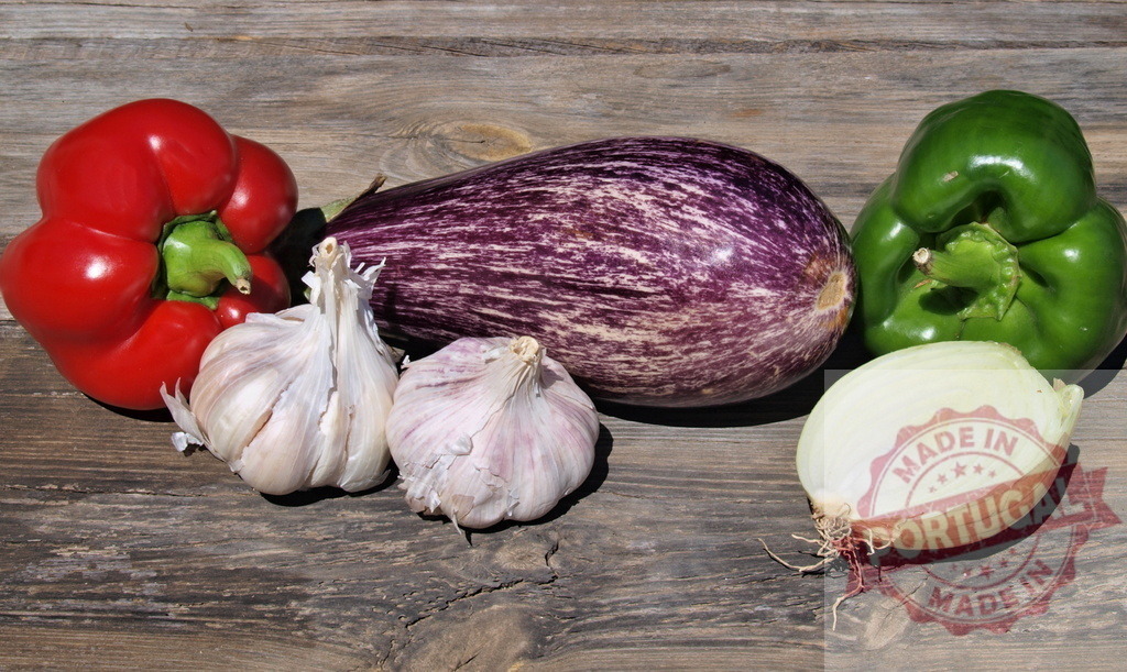 Fresh organic vegetables on rustic wooden background | Fresh organic vegetables including bell peppers, eggplant, garlic, and onion on a rustic wooden surface - Realized with Pictrs.com