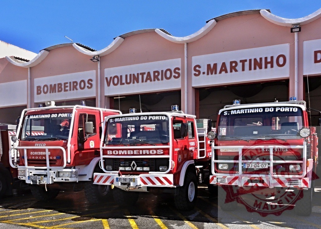 São Martinho do Porto volunteer fire trucks parked at station | Three red fire trucks parked outside a bombeiros voluntários station in Portugal - Realized with Pictrs.com