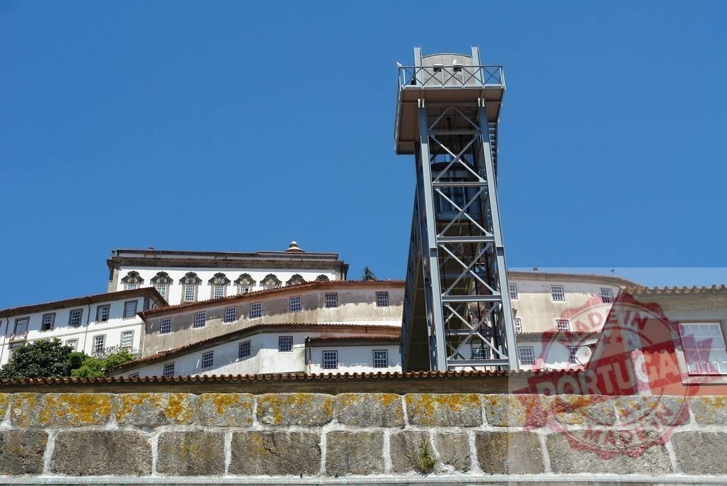 Porto Ladeiro lift structure reaching Ribeira buildings in Porto | Porto Ladeiro lift providing access to historic buildings along the Douro River in Porto - Realized with Pictrs.com