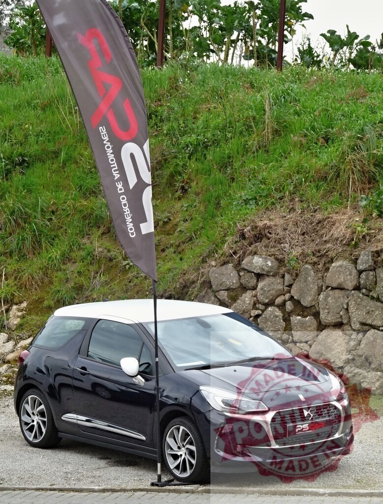 DS 3 hatchback car parking next to PS Car flag | DS 3 car parked outdoors with PS Car dealership flag - Realized with Pictrs.com
