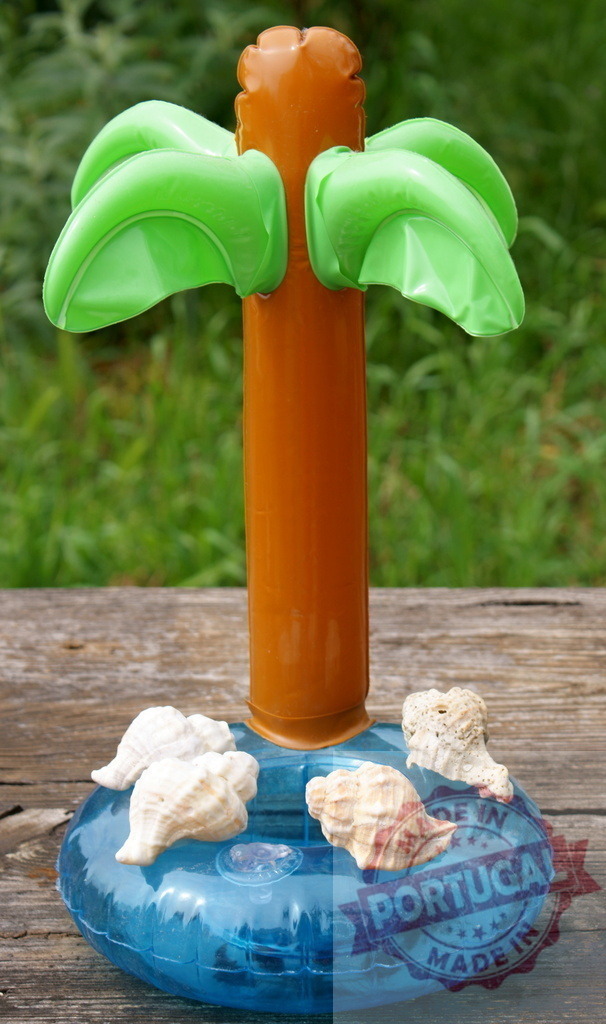 Inflatable palm tree pool float with seashells | Inflatable palm tree cup holder floating on rustic wood surface with seashells - Realized with Pictrs.com