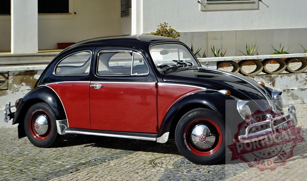 Classic Volkswagen Beetle parked in front of a building | Shiny Volkswagen Beetle parked on a cobblestone street in front of a white building - Realized with Pictrs.com
