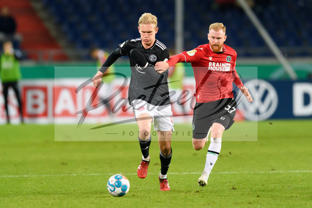 H96DUS20211027_046 | Fussball, Herren: Christoph Klarer (Fortuna Duesseldorf) und Sebastian Kerk (Hannover 96) im Zweikampf bei dem Spiel der 2. Runde im DFB-Pokal zwischen Hannover 96 und Fortuna Duesseldorf in der HDI-Arena am 27.10.2021 in Hannover, Deutschland.DFB / DFL REGULATIONS PROHIBIT ANY USE OF PHOTOGRAPHS AS IMAGE SEQUENCES AND/OR QUASI-VIDEO. - Realisiert mit Pictrs.com
