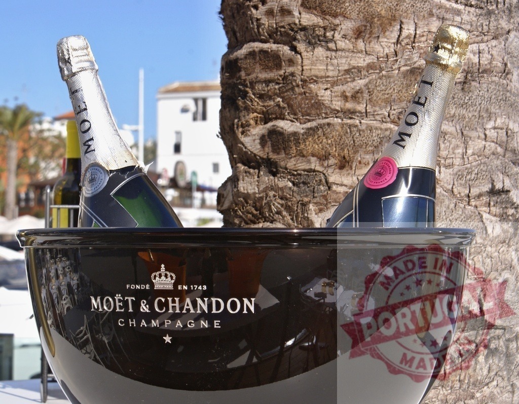 Moët & Chandon Champagne bottles in ice bucket | Two Moët &amp; Chandon Champagne bottles chilling in an ice bucket outdoors next to a palm tree - Realized with Pictrs.com