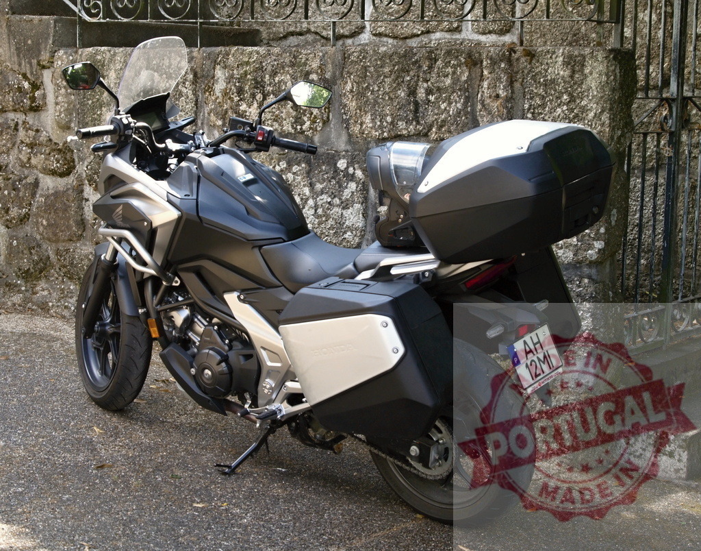 Honda NT1100 motorcycle parked near stone wall | Modern touring motorcycle Honda NT1100 parked near an old stone wall - Realized with Pictrs.com