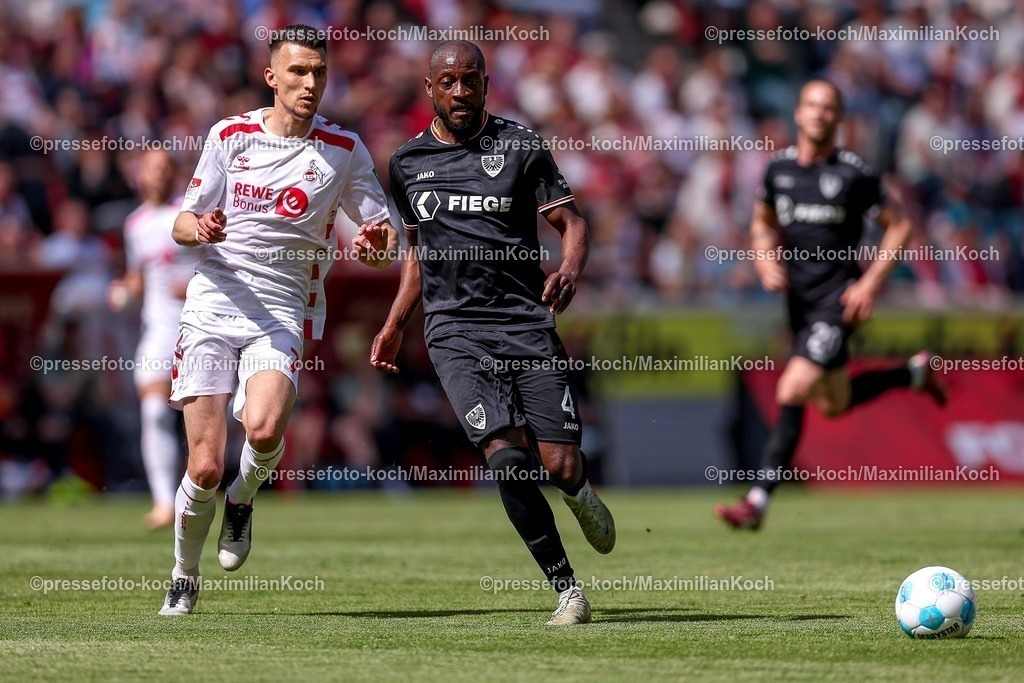 1FC20042501058 | 20.04.2025, Fußball, 1. FC Köln - Preußen Münster, 2.. Fußball Bundesliga, 30. Spieltag, RheinEnergie-STADION, Saison 2024 2025: David Kinsombi (Preussen Muenster #04) im Zweikampf gegen Dejan Ljubicic (FC Koeln #7) DFB regulations prohibit any use of photographs as image sequences and or quasi-video.