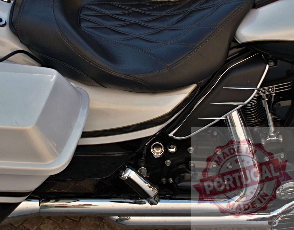 Custom cruiser motorcycle detail showing seat engine and chrome | Custom black and white motorcycle showing upholstered seat, engine, exhaust pipe, and saddlebag - Realized with Pictrs.com