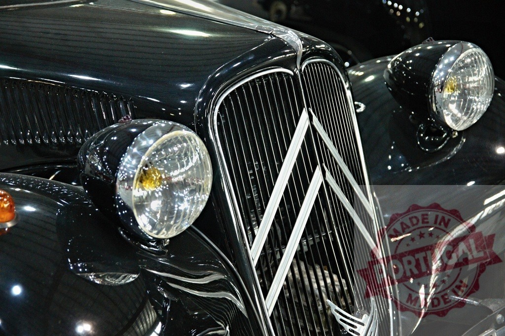 Citroën Traction Avant showing headlights and radiator grille | Close-up of a vintage Citroën Traction Avant, highlighting its iconic headlights and radiator grille - Realized with Pictrs.com