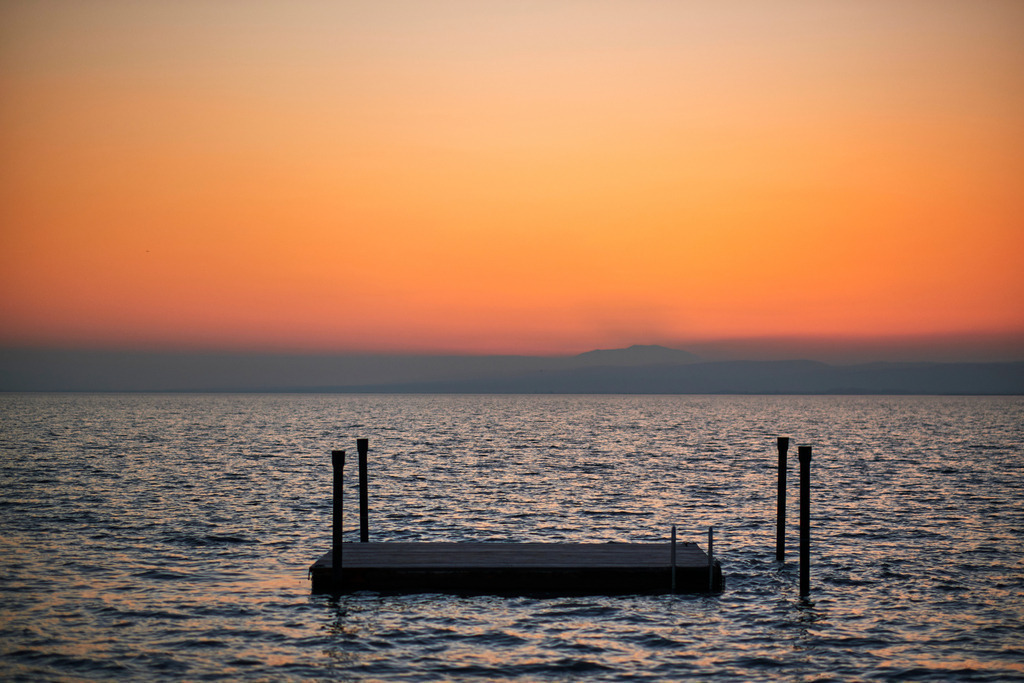 Schwimmplattform im Neusiedlersee im Sonnenuntergang | Weiden am See, Austria - March 01, 2021: Schwimmplattform im Neusiedlersee im Sonnenuntergang. - Realisiert mit Pictrs.com