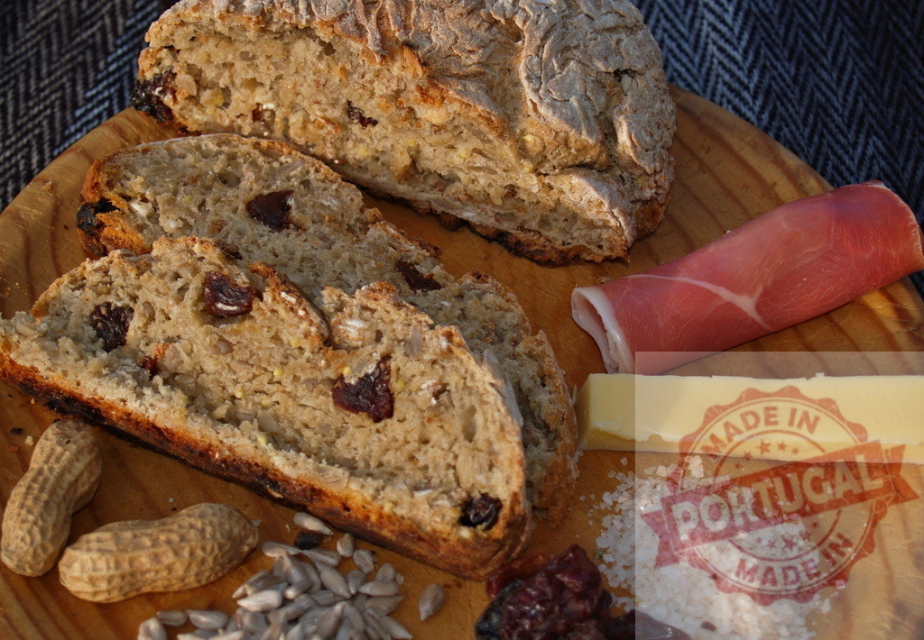 Rustic irish soda bread with ham and butter | Rustic board with sliced soda bread, ham, butter, salt, peanuts, and sunflower seeds - Realized with Pictrs.com