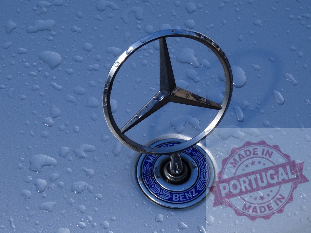 Mercedes Benz hood ornament with rain drops | Mercedes Benz hood ornament reflecting sunlight and collecting rain drops on a silver car - Realized with Pictrs.com