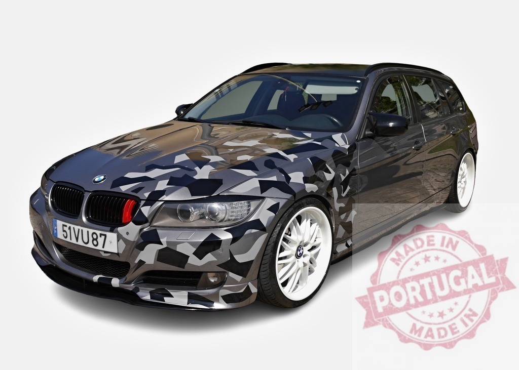 Customized BMW 3 Series Touring with camouflage vinyl wrap showcasing urban style | Stylish gray BMW 3 Series Touring featuring a unique camouflage vinyl wrap, white alloy wheels, and a sporty front splitter - Realisiert mit Pictrs.com