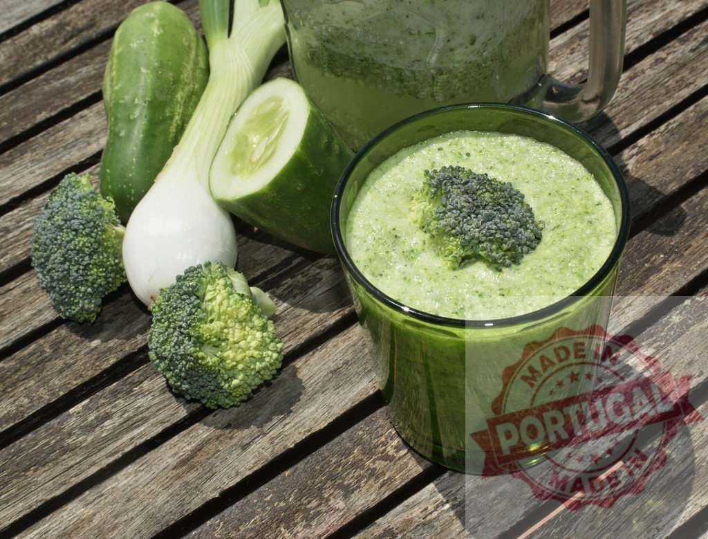 Green smoothie with healthy fresh vegetables on wood | Green smoothie blending fresh broccoli, cucumber, and scallion on a rustic wooden table for healthy eating - Realized with Pictrs.com