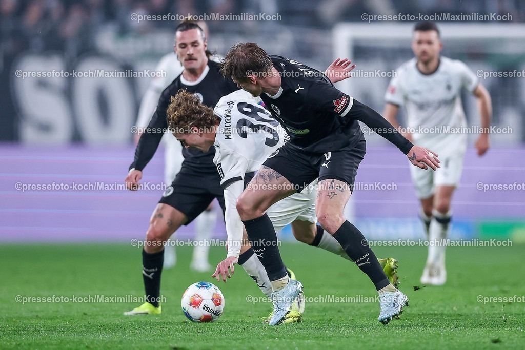BMG13032601040 | 13.03.2026, Fußball, Borussia Mönchengladbach - FC St. Pauli, 1. Fußball Bundesliga, 26.Spieltag, Borussia-Park, Saison 2025 2026: Jackson Irvine&nbsp;(FC St.Pauli #07) Eric Smith&nbsp;(FC St.Pauli #08) im Zweikampf gegen  Hugo Bolin&nbsp;(Borussia Mönchengladbach #38)  DFB regulations prohibit any use of photographs as image sequences and or quasi-video.
