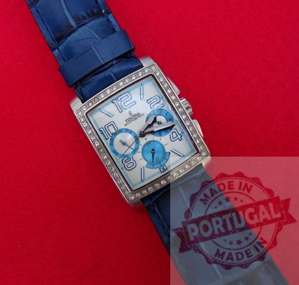 Festina multifunction wristwatch with blue leather strap | Festina multifunction wristwatch showing crystals, blue leather strap, and chronograph on red background - Realisiert mit Pictrs.com