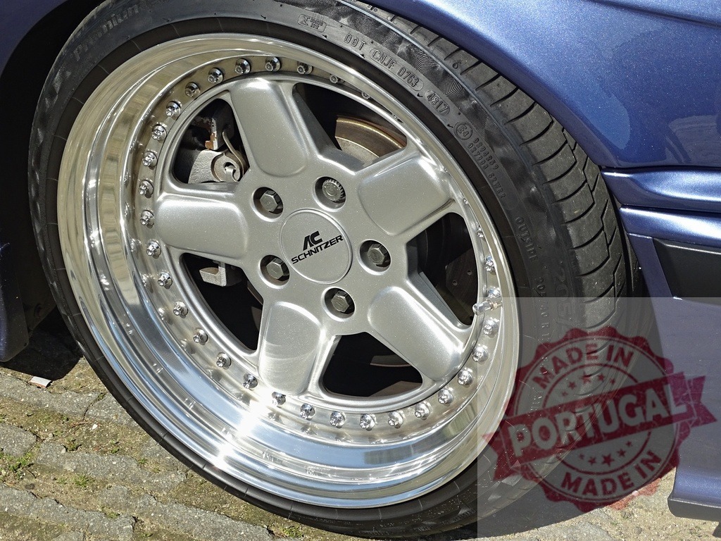 AC Schnitzer wheel on custom tuned car | AC Schnitzer alloy wheel and tire on deep blue car, showing automotive tuning detail - Realized with Pictrs.com