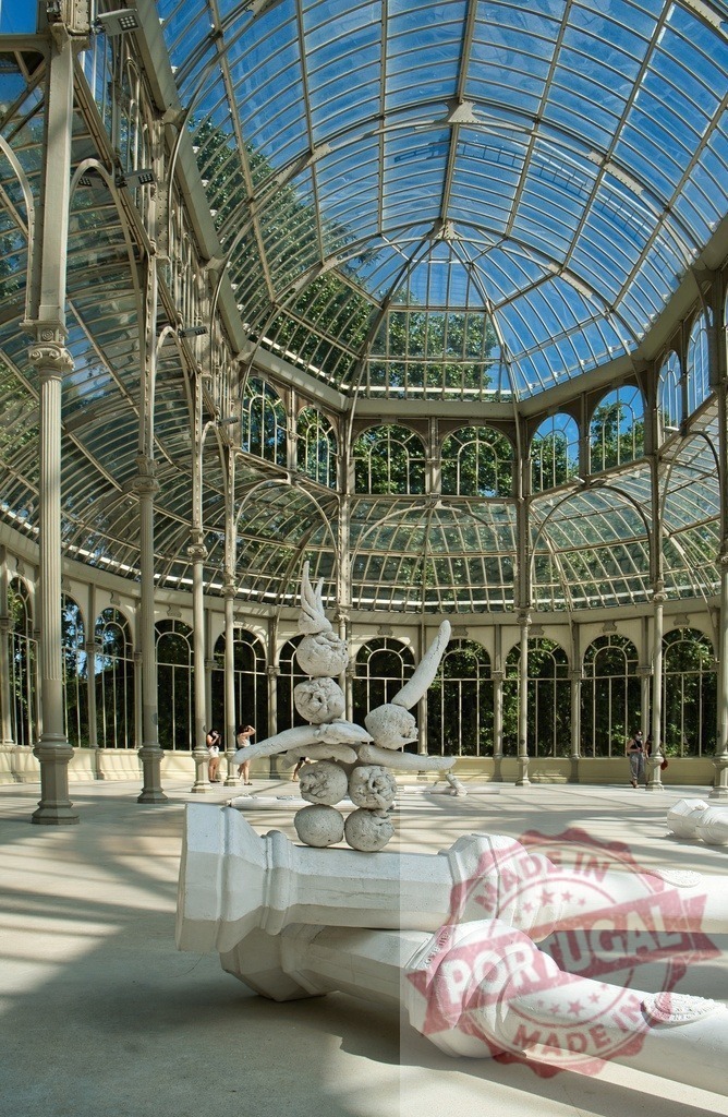 Palacio de Cristal interior with modern sculptures, Madrid | Palacio de Cristal showcasing its glass architecture and contemporary art installation inside - Realized with Pictrs.com
