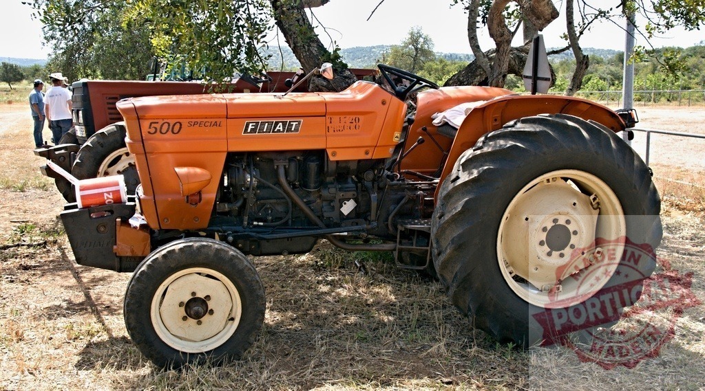 Fiat 500 Special vintage farm tractor parked outdoors | Orange Fiat 500 Special vintage tractor standing on dry ground in farmland - Realized with Pictrs.com