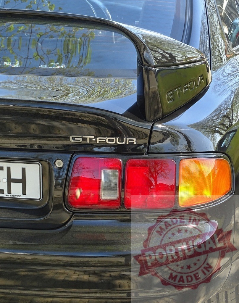 Black Toyota Celica GT-FOUR rear view | Black Toyota Celica GT-FOUR car detail showing rear spoiler and tail lights - Realized with Pictrs.com