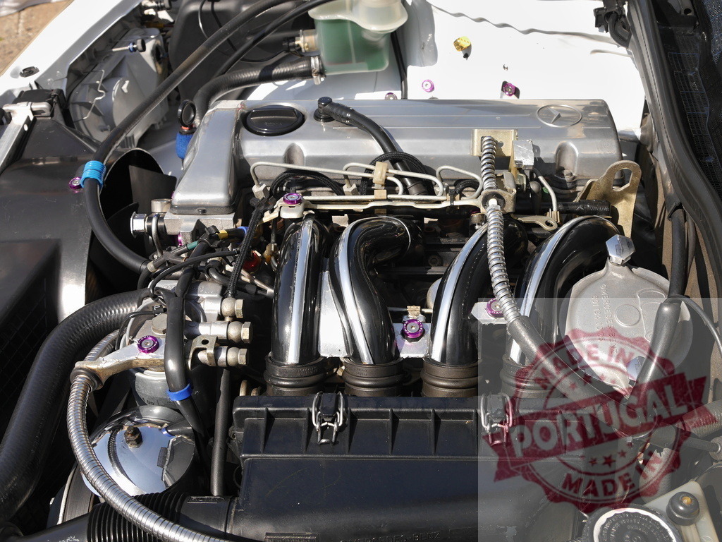 Mercedes-Benz engine bay showing polished chrome details | Mercedes-Benz car engine with chrome intake manifold and custom purple bolts - Realized with Pictrs.com
