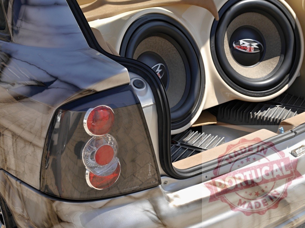 Vehicle trunk revealing subwoofers for audio system | Car trunk showing powerful subwoofers and audio amplifiers for sound customization - Realized with Pictrs.com