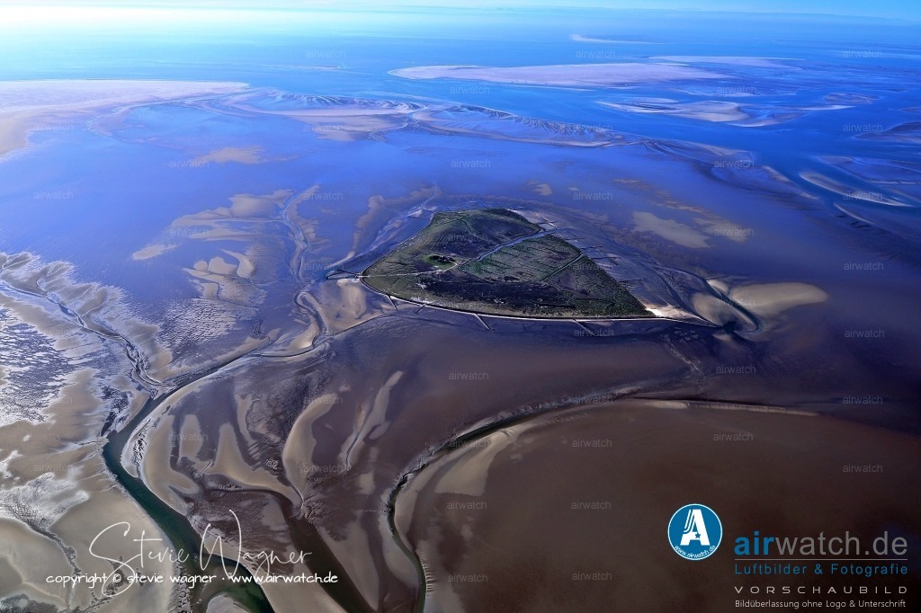 Luftbild Hallig Süderoog - Süderoog wird ganzjährig von einer Familie bewohnt. | Süderoog wird ganzjährig von einer Familie bewohnt. Sie sind als Ranger und Wasserbauer beim Landesbetrieb für Küstenschutz, Nationalpark und Meeresschutz angestellt und tragen so zur Erhaltung des Nationalparks Schleswig-Holsteinisches Wattenmeer bei, in dessen Schutzzone I die Hallig liegt.