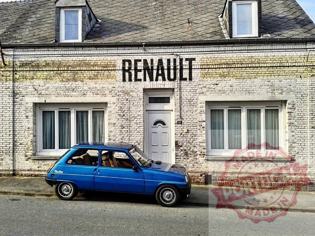 Blue Renault 5 Turbo parked at old garage | Blue Renault 5 Turbo parked in front of an old brick building with RENAULT sign - Realized with Pictrs.com