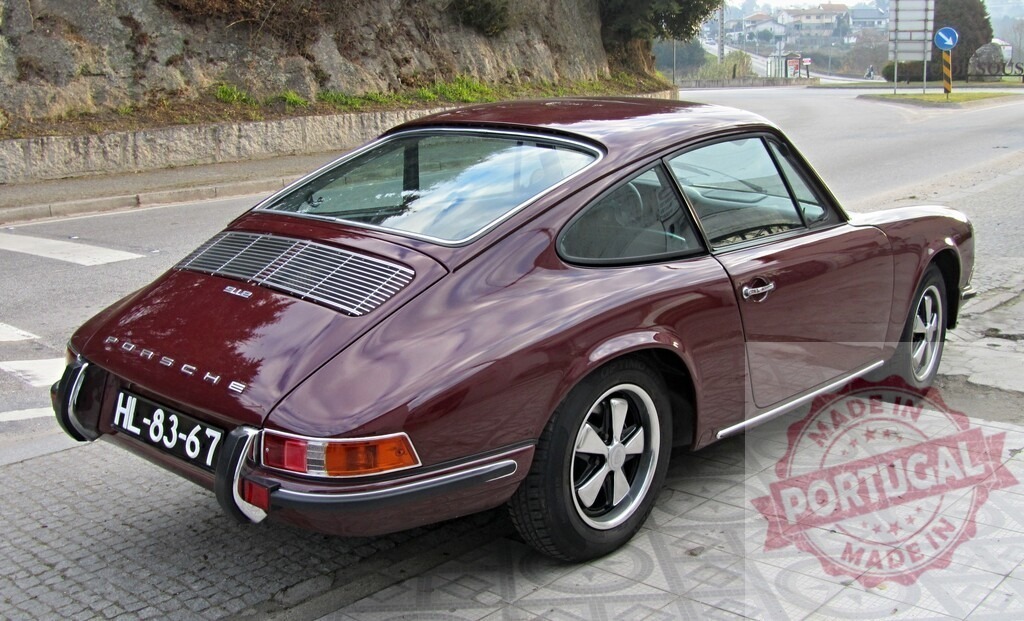 Burgundy Porsche 912 parked near a road junction | Classic Porsche 912 parked on a tiled sidewalk near a road junction, showcasing its timeless design - Realized with Pictrs.com