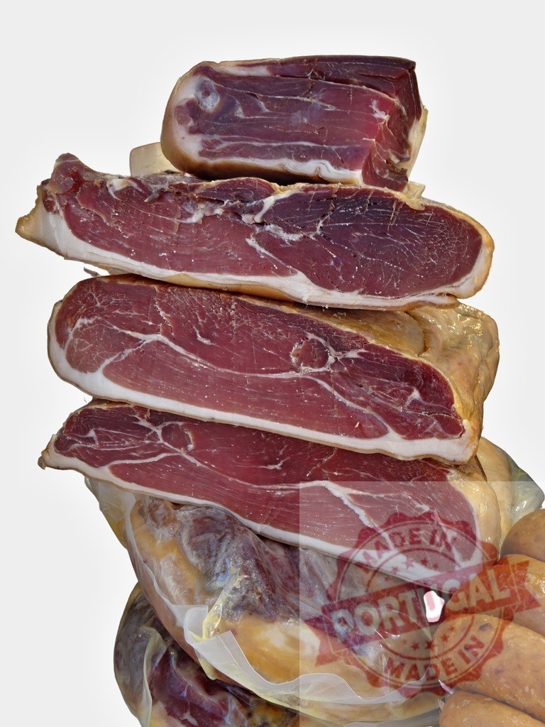 Stack of dry-cured ham and sausages | Stacked vacuum-packed dry-cured ham and sausages creating a gourmet food selection - Realized with Pictrs.com