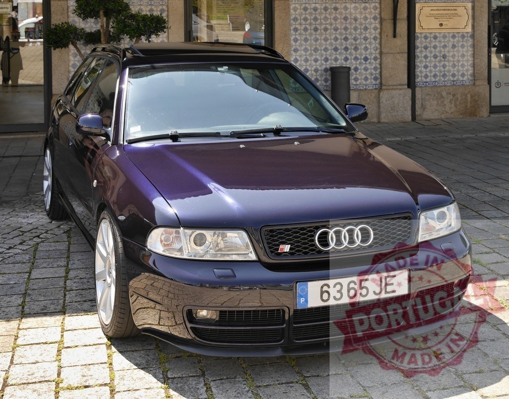 Audi S4 B5 Avant parked on cobblestone street | Purple Audi S4 B5 Avant car parked on a cobblestone street in front of a building - Realized with Pictrs.com