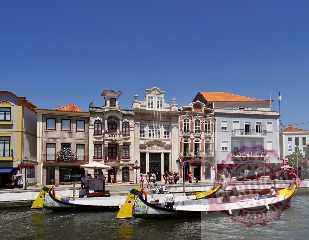 Aveiro canals with traditional Moliceiro boats Portugal. Aveiro - Portugal | Colorful Moliceiro boats navigating the Ria de Aveiro canal in Portugal - Realized with Pictrs.com