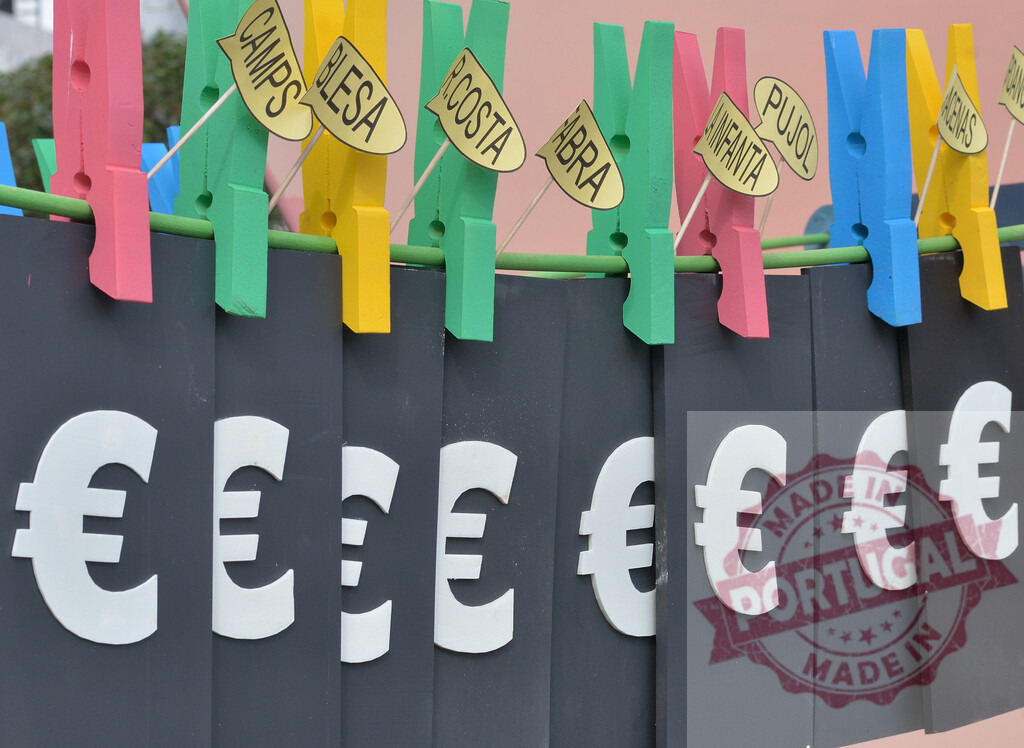 Spanish political corruption launders euro money on clothesline. Fallas Fiestas Communidad Valenciana | Euro symbols hang on a clothesline with names of politicians, representing money laundering and corruption - Realized with Pictrs.com