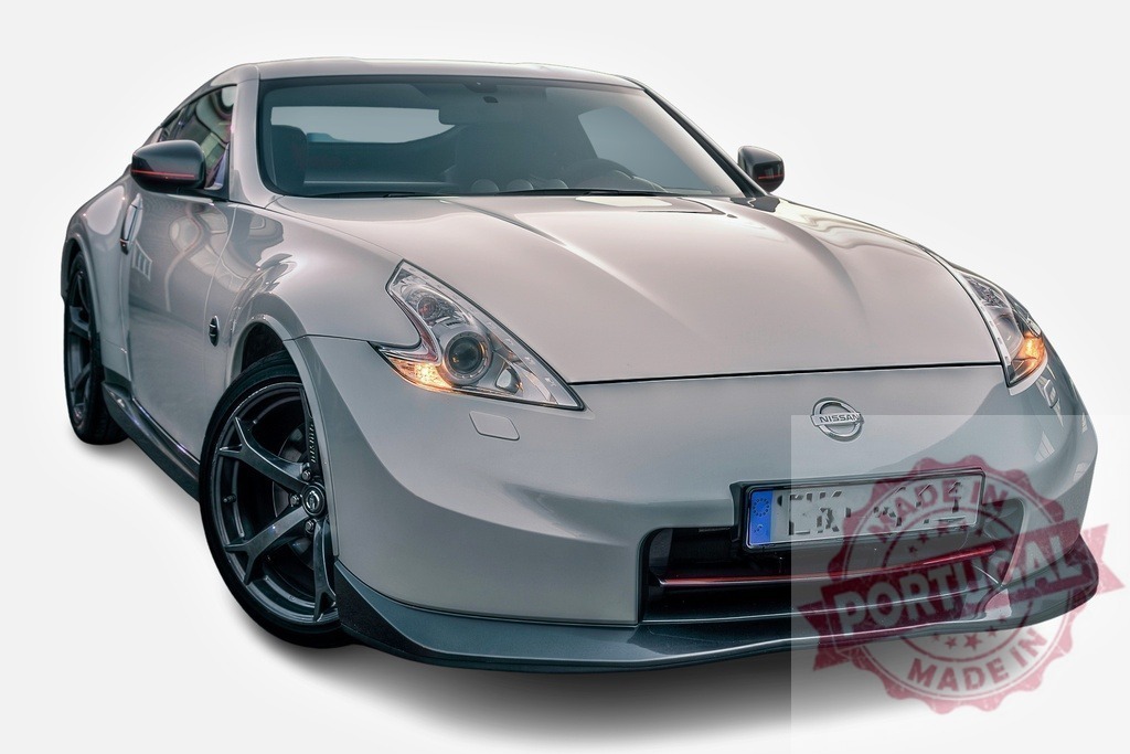 Nissan 370z sports car posing with lights on | Modern gray Nissan 370Z coupe posing with lights on against white background - Realized with Pictrs.com