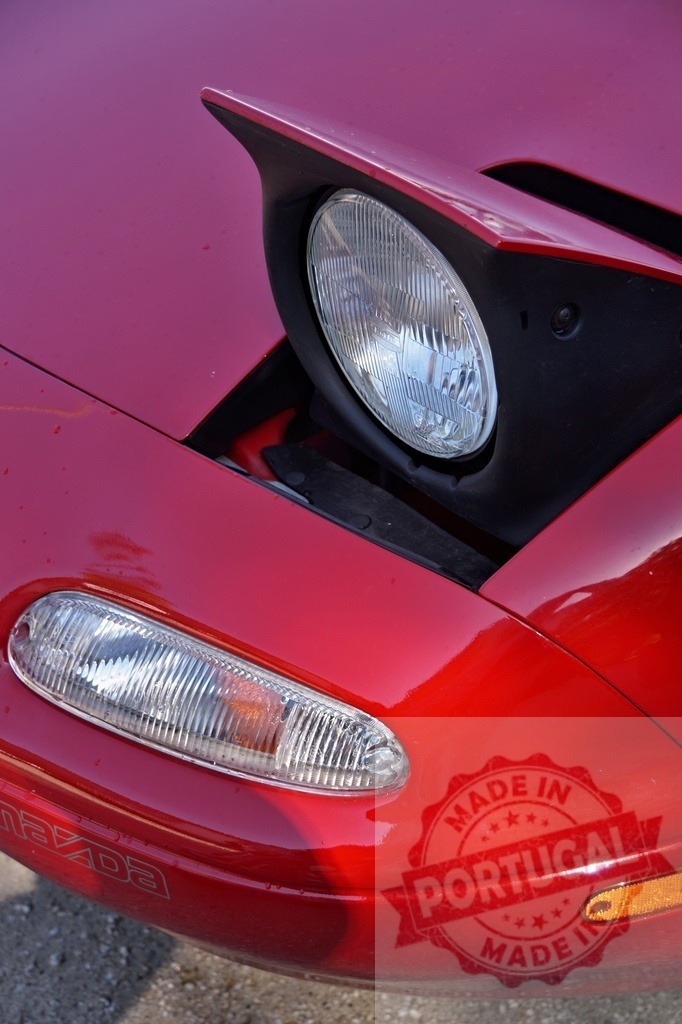 Mazda MX-5 Miata red car pop-up headlight and turn signal | Mazda MX-5 Miata featuring an iconic pop-up headlight and front turn signal - Realized with Pictrs.com