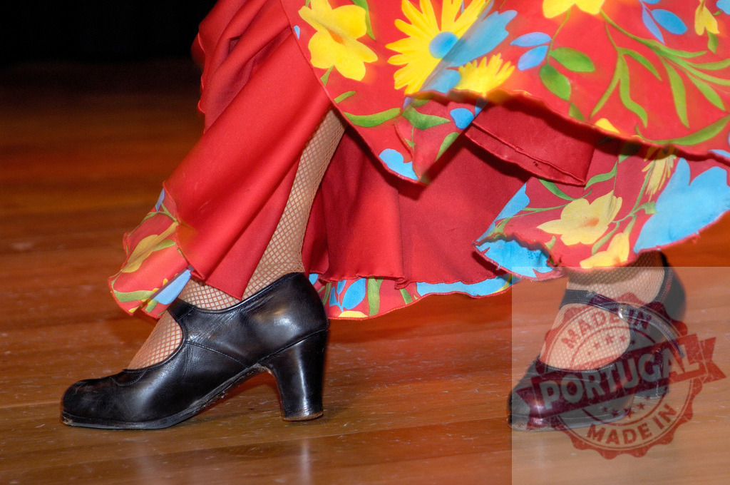 Flamenco dancer performing with traditional red dress and shoes | Dancer feet moving to the rhythm, wearing black flamenco shoes, fishnet stockings, and a patterned red dress - Realized with Pictrs.com
