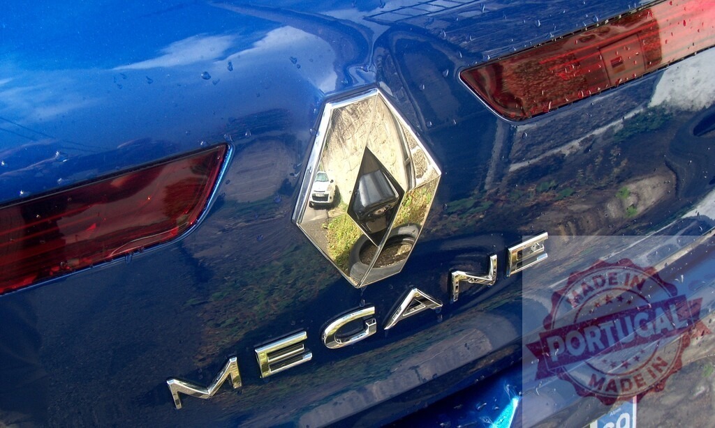 Renault Mégane car rear logo and blue paint | Renault diamond logo and Mégane lettering on a wet blue vehicle - Realisiert mit Pictrs.com