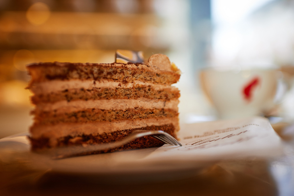 Cafe Hübler | Wien, Austria - January 16, 2019: Cafe Hübler; eine Hüblertorte mit Melange steht auf dem Tisch im Verkaufsraum. - Realisiert mit Pictrs.com