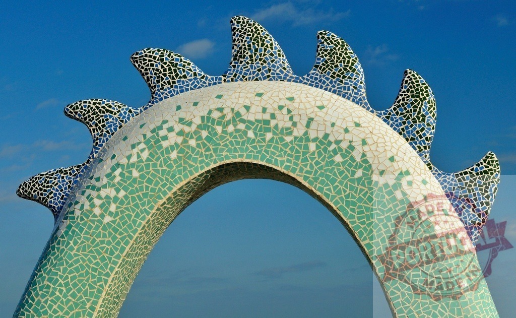 Park Güell dragon mosaic art against blue sky. Provincia de Castellon | Detailed view of famous mosaic dragon sculpture tail at Park Güell - Realized with Pictrs.com