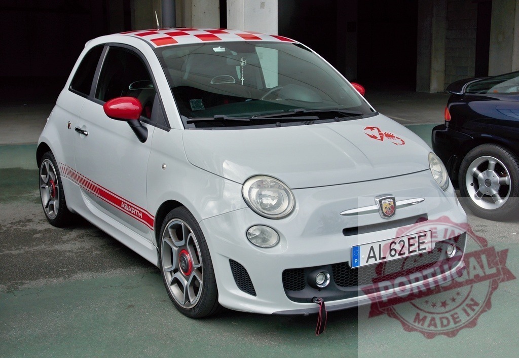 Customized Abarth Fiat 500 parking in garage | White tuned Fiat 500 Abarth with red checkered roof and scorpion sticker parked in a public garage - Realized with Pictrs.com