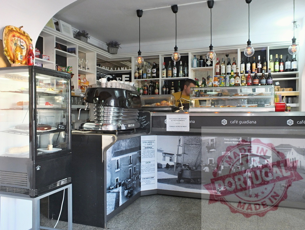 Counter and espresso machine inside a vintage cafe | Bartender preparing drinks behind a counter with vintage decor and espresso machine - Realized with Pictrs.com