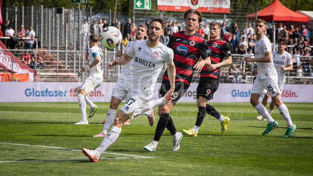 Viktoria Koeln vs. SV Wehen Wiesbaden, 11.04.2026 | KOELN, GERMANY - APRIL 11, 2026:  Lukas Schleimer (SV Wehen Wiesbaden, 37), Tim Kloss (Viktoria Köln, 18) during the 3rd division match between Viktoria Koeln vs. SV Wehen Wiesbaden at the Sportpark Hoehenberg on matchday 7 on April 11, 2026 in Koeln, Germany. DFL REGULATIONS PROHIBIT ANY USE OF PHOTOGRAPHS AS IMAGE SEQUENCES AND/OR QUASI-VIDEO.